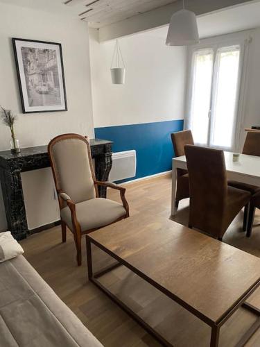 a living room with a couch and chairs and a table at L'étape Champenoise in Ay
