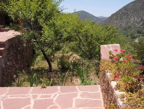 a stone wall with a view of a mountain at Villa Romancia Ourika Vallee in Marrakech