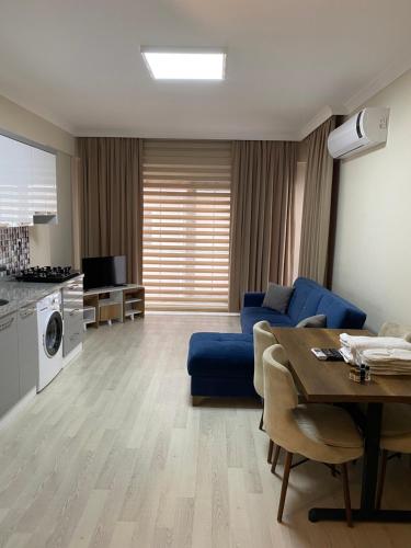 a living room with a blue couch and a table at BALEK APART in Pelitli