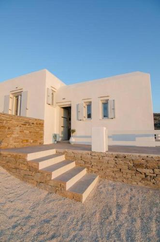 a house with stairs in front of a building at Sea and Sun l in Mylopotas