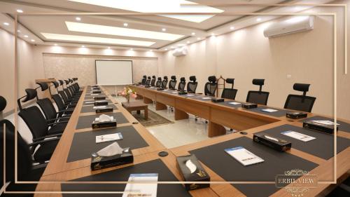 a conference room with a long table and chairs at Erbil View Hotel in Erbil