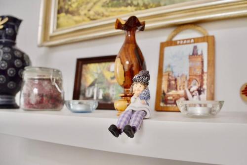 a shelf with a picture and a doll on it at Family Home in Budapest