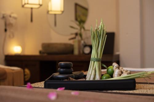 a table with a vase of vegetables on a table at EBINO PULUONG RESORT and SPA in Pu Luong