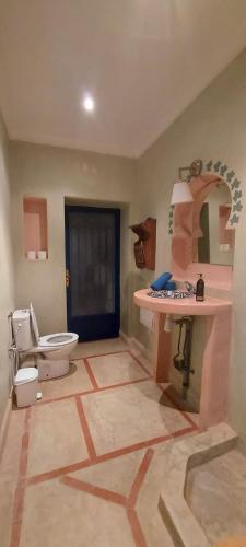 a bathroom with a toilet and a sink at villa Marrakech raja in Marrakesh