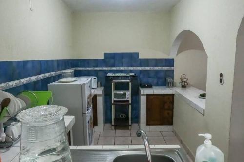 a kitchen with a sink and a counter top at Casa la Ermita in Antigua Guatemala