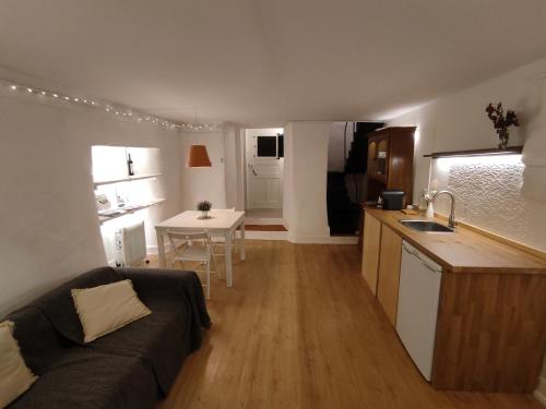 a living room and kitchen with a couch and a table at Historic Torres Vedras in Torres Vedras