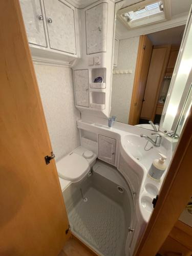 a small bathroom with a sink and a toilet at Cozy Caravan in Vestmannaeyjar