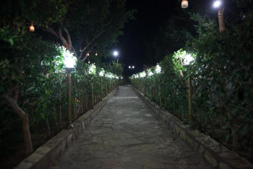 a walkway at night with a row of lights at Aphrodite View in Korakiaí