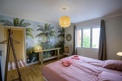 a pink stuffed pig laying on a bed in a bedroom at Chez Odette - SPA, Barbecue, Parking in Albi