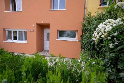 a orange building with a white door and flowers at Chez Odette - SPA, Plancha, Parking in Albi