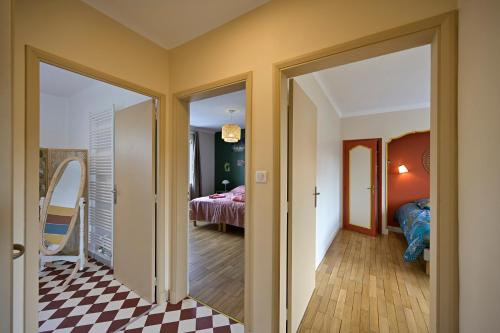 a hallway with a room with a bed and a mirror at Chez Odette - SPA, Plancha, Parking in Albi
