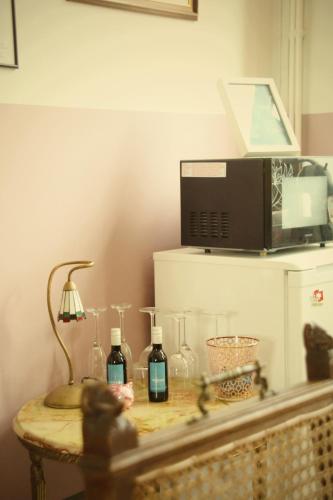 a table with two bottles of wine and a microwave at B&B Herenhuis1919 in Lo-Reninge