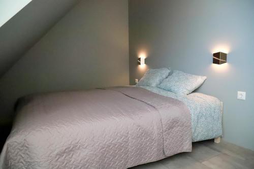 a bedroom with a white bed with two pillows at Kassikäpa villa in Haapsalu