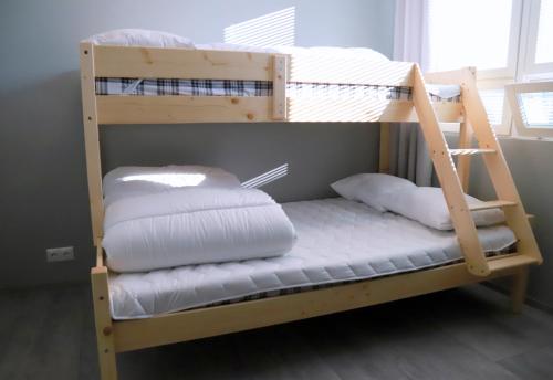 a bunk bed with white pillows on it at Kassikäpa villa in Haapsalu