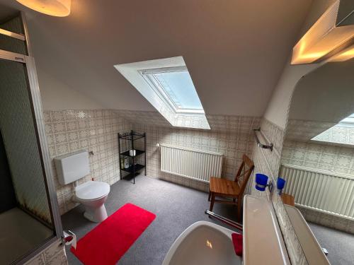 a bathroom with a sink and a toilet with a skylight at Private Spacious Villa near Winterberg and Willingen 14 Guests HUGE GARDEN Free Parking for Multiple Cars in Olsberg