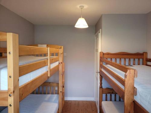 a room with two bunk beds and a hallway at Cottage by the sea Greencastle in Greencastle