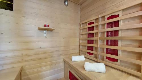 a sauna with two white towels sitting on a wooden bench at Villa Amoena with Pool and Sauna in Brtonigla