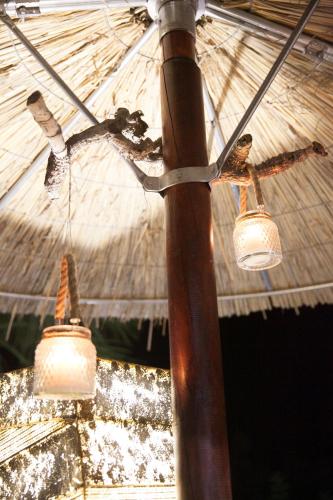 a pole with two lights and an umbrella at Aphrodite View in Korakiaí