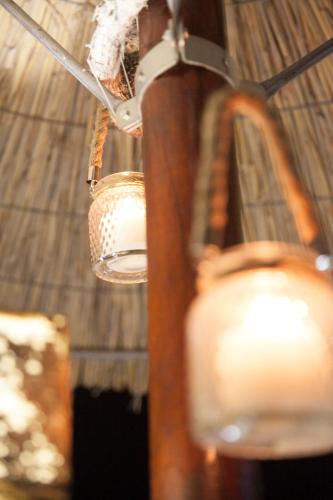 a light hanging from a wooden pole with a candle at Aphrodite View in Korakiaí