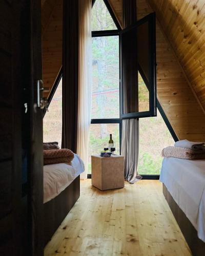 a bedroom with two beds and a large window at House of memories in Surami