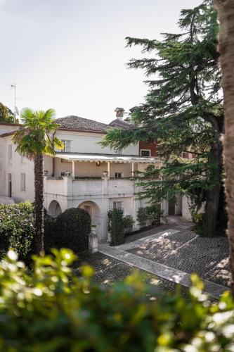 a building with a palm tree in front of it at Hotel Palazzo Novello in Montichiari