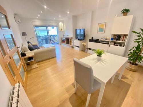 a living room and dining room with a table and chairs at Coast apartment near Barcelona in Sant Andreu de Llavaneres