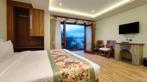 a bedroom with a bed and a fireplace and a television at Mount Polaris Suites & Spa in Kalimpong