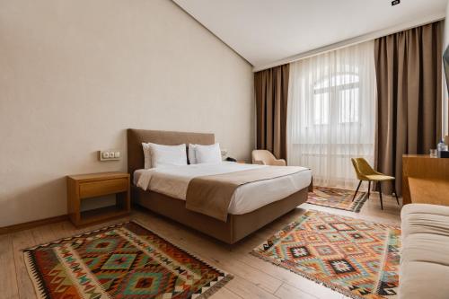 a hotel room with a bed and a couch at MODERNO Hotel in Tashkent