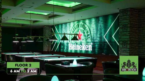 a restaurant with tables and a sign that reads harbringer at Arman Hotel Juffair Mall in Manama