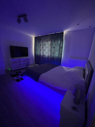 a bedroom with a bed with a blue light at Karlsburg Studio in Alba Iulia