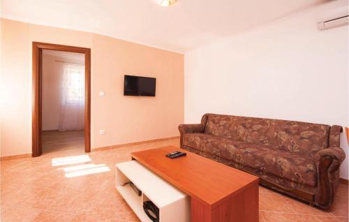a living room with a couch and a coffee table at Apartment Sibenik With Sea View Xi in Krapanj
