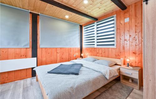a bedroom with a bed and a large window at Gorgeous Home In Jalsje With Sauna in Martinišće