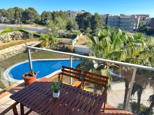 a wooden table and two chairs on a balcony at Domuum Holidays - PARADISE VILLAGE in Salou