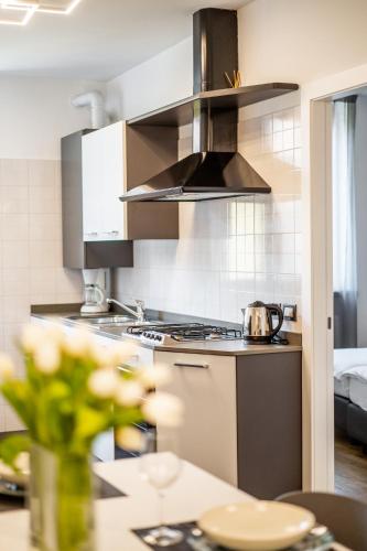 a kitchen with a sink and a stove top oven at Appartamenti Vasco Renna Surf Center in Nago-Torbole