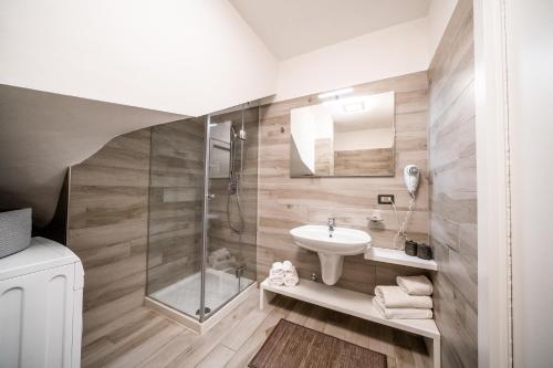 a bathroom with a sink and a shower at Appartamenti Vasco Renna Surf Center in Nago-Torbole