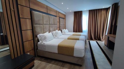 a hotel room with two beds and a window at Hilal Palace - Halal in Golem