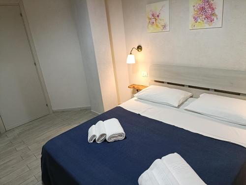 a bedroom with a large bed with two towels on it at B&B villa orchidea in Ricadi