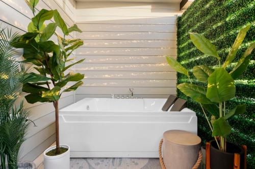 a bathroom with plants and a bath tub at Lago Vista Home with Game Room and Outdoor Tub! in Lago Vista