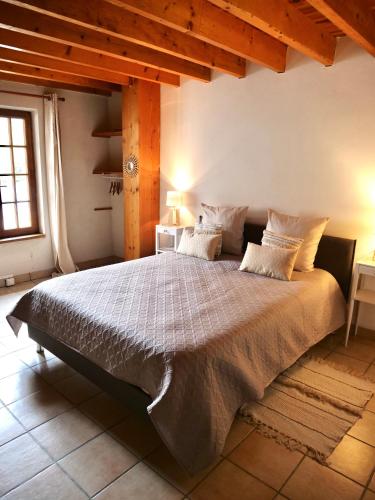 a bedroom with a large bed in a room at Domaine du Cellier de la Couronne in Sézanne