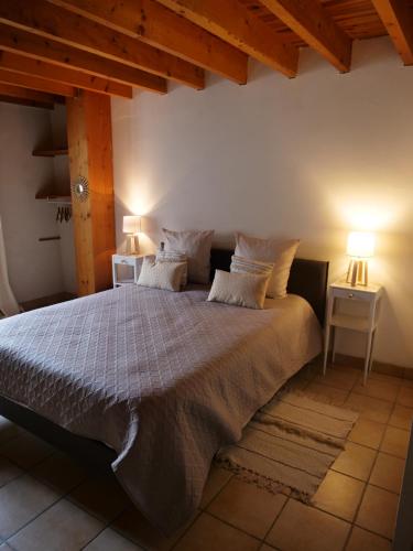 a bedroom with a large bed with two lamps at Domaine du Cellier de la Couronne in Sézanne