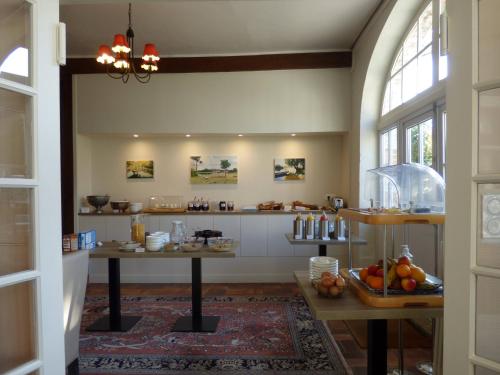a kitchen with a counter with food on it at Hôtel La Tonnellerie in Beaugency