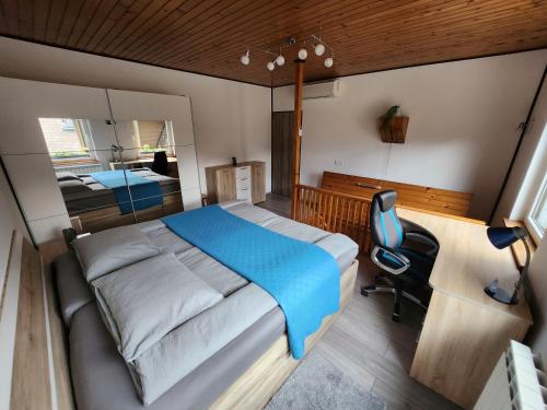 a bedroom with a bed and a desk and a chair at Apartma CIK in Bovec