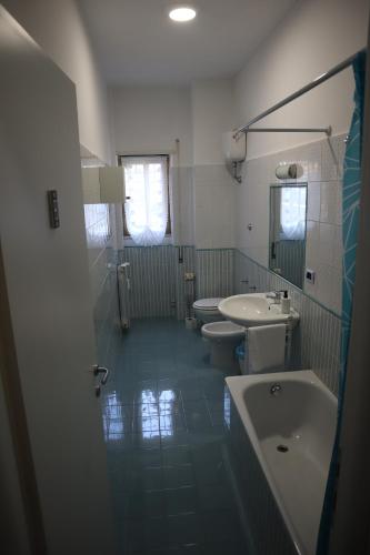 a bathroom with two sinks and two toilets at Lavinia house in Lido di Ostia