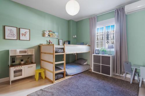 a childs bedroom with a bunk bed and a desk at Beautiful duplex apartment in Fuengirola in Fuengirola
