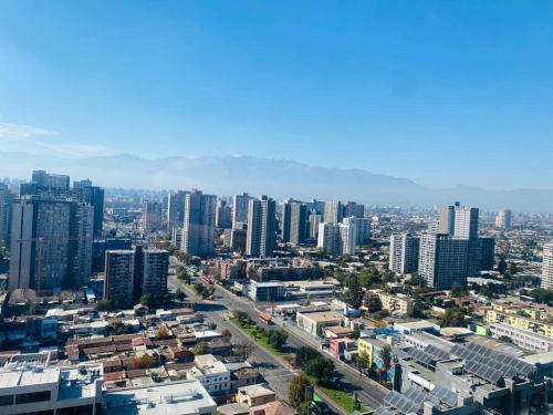 an aerial view of a city with tall buildings at Vista Cordillera Studio in Santiago