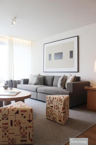 a living room with a couch and a table at Azores Essence - Coliseu in Ponta Delgada