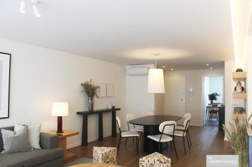 a living room and dining room with a table and chairs at Azores Essence - Coliseu in Ponta Delgada