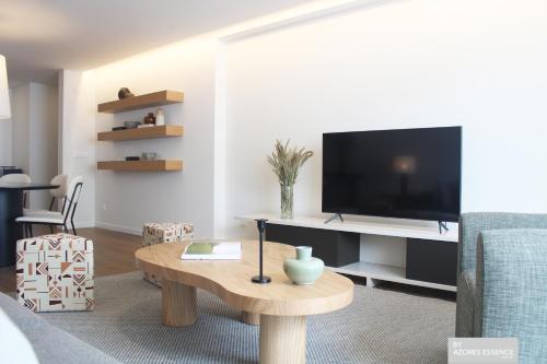 a living room with a tv and a coffee table at Azores Essence - Coliseu in Ponta Delgada