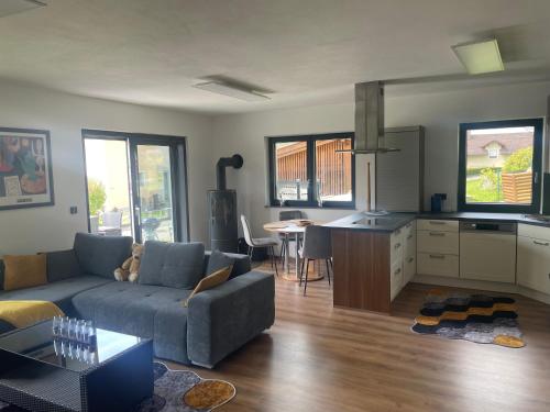 a living room with a couch and a kitchen at Ferienhaus Herre in Freinberg