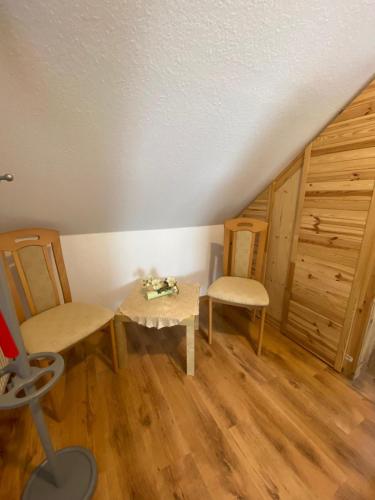 a small room with two chairs and a table at Dachgeschoss Apartment mit Ausblick in Halle an der Saale